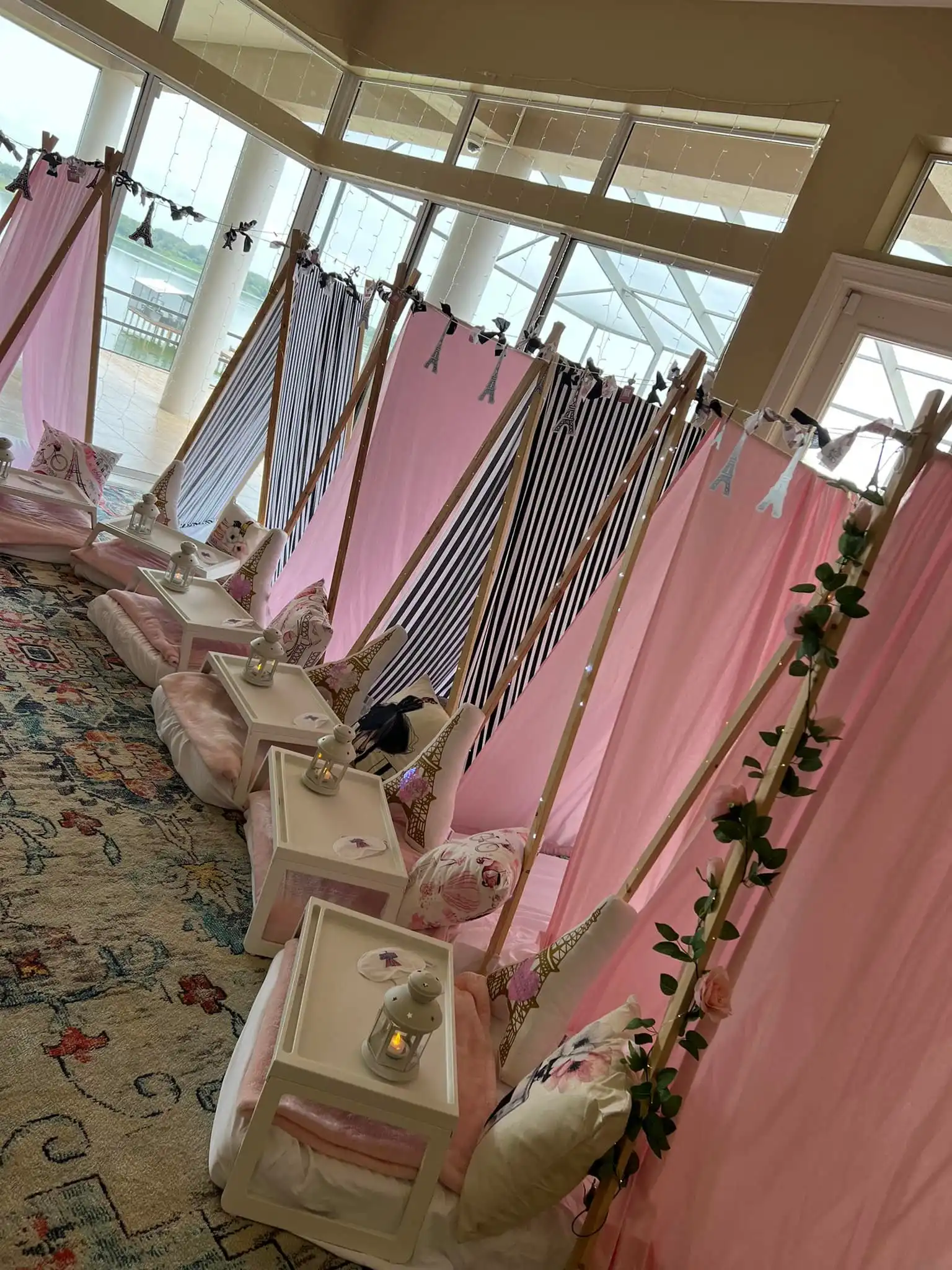 Pink teepee tents for a girl's birthday party, complete with a "Build a Buddy" workshop.