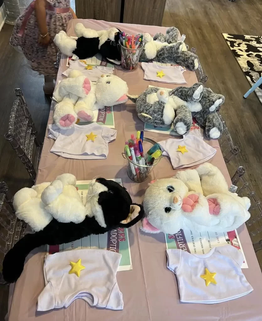 A table full of stuffed animals and slime on a table.